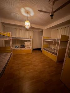 a room with bunk beds and a ceiling at Yaro Backpackers Hostel in Guwahati +40 photos