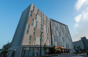 a tall building with a lot of windows at Leonardo Royal Hotel Venice Mestre in Mestre