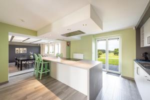 a kitchen with a counter and a dining room at Mossefat in Sprimont