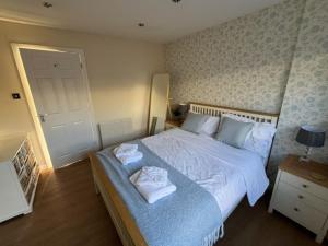 a bedroom with a large bed with towels on it at Walworth Castle Cottage in Darlington