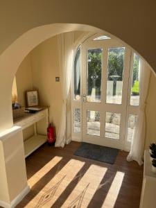 an arched entryway with a door and a window at Walworth Castle Cottage in Darlington