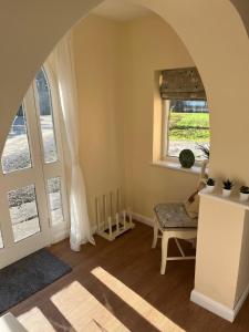 an arched room with a chair and a window at Walworth Castle Cottage in Darlington