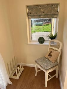 a small room with a chair and a window at Walworth Castle Cottage in Darlington +10 photos
