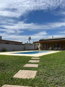 a house with a swimming pool in the yard at La Matera de Hugo in Lobos