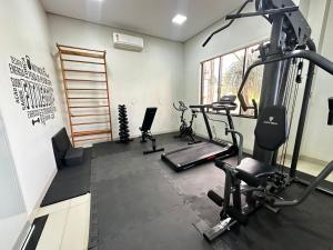 a gym with two tread machines and a treadmill at Hotel Pousada Real in Sinop