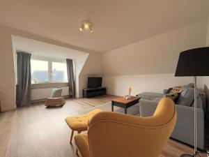 a living room with a couch and a tv at Hallighafen in Bredstedt