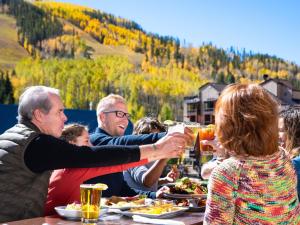 a group of people sitting at a table drinking beer at Vantage Point in Vail