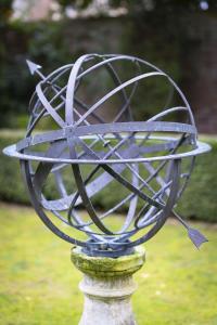 a metal bowl on top of a statue at Pool House at Mill Cottage in Goring