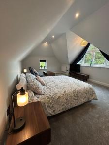 a bedroom with a large bed in a attic at Goring River Retreat with Gym and Wellness Area in Goring