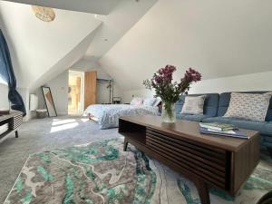 a living room with a couch and a table at Goring River Retreat with Gym and Wellness Area in Goring