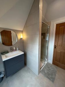 a bathroom with a sink and a shower with a mirror at Goring River Retreat with Gym and Wellness Area in Goring +31 photos