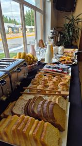 a buffet with various types of bread and pastries at Hotel Americano in Perito Moreno +8 photos