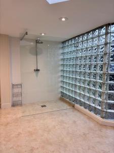 a room with a large wall of glass wine bottles at The Baydon House Luxury Studio in Marlborough