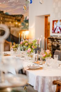 a long table with candles and flowers on it at Apartment Prenzlauer Berg in Berlin