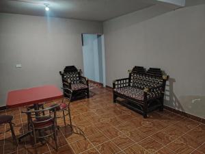 a room with three chairs and a table and a table and stool at Estancia kv in Coatepec