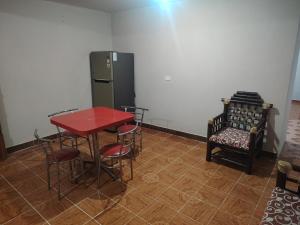 a room with a table and chairs and a refrigerator at Estancia kv in Coatepec