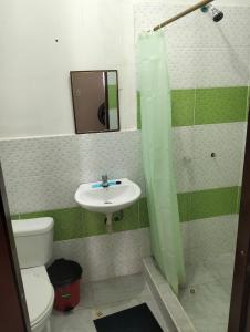 a bathroom with a sink and a toilet at PAULIN Surf in Montañita