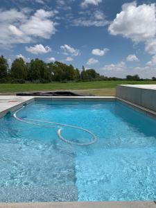 a large swimming pool with a water hose in it at Sunset View Vaal De Grace in Grooteiland