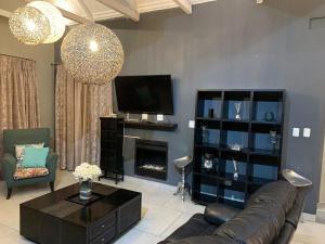 a living room with a couch and a tv at Sunset View Vaal De Grace in Grooteiland