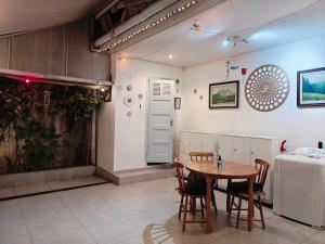 a kitchen with a table and chairs in a room at Vila Urban Hostel ॐ Jardins in São Paulo