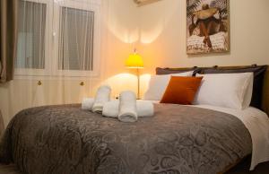 a bedroom with a large bed with towels on it at Square House in Levkopiyí