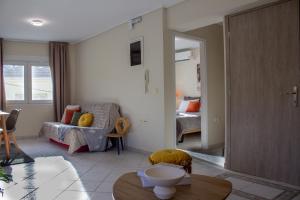 a living room with a couch and a bed at Square House in Levkopiyí