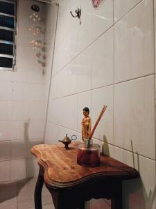 a wooden table with a figurine on top of it at Vila Urban Hostel ॐ Jardins in São Paulo