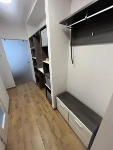 a room with a closet with a bench in it at Apartmán Ella - Riegrova 41 in Děčín +9 photos