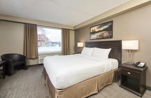 a hotel room with a large bed and a window at Canad Inns Destination Centre Transcona in Winnipeg +27 photos