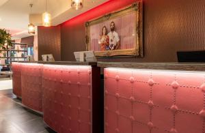 a bar in a restaurant with a picture on the wall at NYX Hotel Milan by Leonardo Hotels in Milan