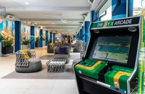 a video game arcade in a lobby with a pool at NYX Hotel Milan by Leonardo Hotels in Milan +85 photos