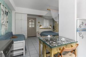 a bedroom with a bed and a kitchen with a table at Debbie's Apartments in Adamantas +16 photos