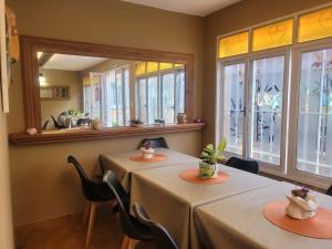 two tables in a room with windows at Tercer Ojo Apart Hotel in Capilla del Monte