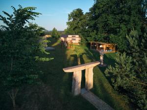 an overhead view of a stone bench in a yard at Arboretum Vlasenice in Vlasenice +32 photos