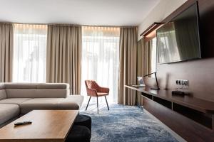 a living room with a couch and a table at Hotel Marton in Koszalin