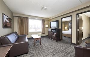 a hotel room with a couch and a bed at Canad Inns Destination Centre Transcona in Winnipeg