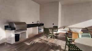 a living room with a table and chairs at Beach Loft Style and Beach Heated Pool in Mazatlán +38 photos