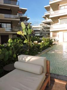 a white chair sitting on top of a building at Beach Loft Style and Beach Heated Pool in Mazatlán