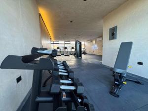 a gym with a row of chairs in a room at Beach Loft Style and Beach Heated Pool in Mazatlán