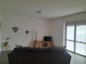 a living room with a couch and a tv at Casa Vacanza dei Nonni in Varzo