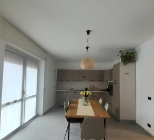 a kitchen and dining room with a table and chairs at Casa Vacanza dei Nonni in Varzo