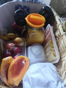 a basket filled with fruits and vegetables and a jar of juice at Chalés Beira Rio in Santo Antônio do Pinhal +20 photos