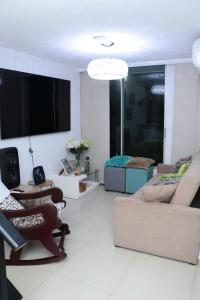 a living room with a couch and a flat screen tv at Spazio83 in Puerto Colombia +4 photos