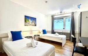a hotel room with two beds and a window at BEGE APARTMENTS CitySleep in Aachen