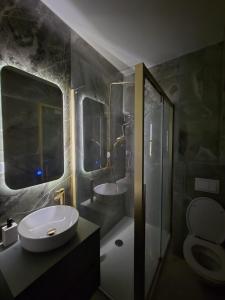 a bathroom with a sink and a toilet and a shower at Splendida in Bosanska Gradiška +7 photos