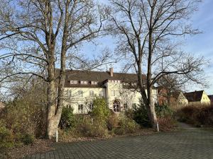 a large white house with trees in front of it at Haus Lutherrose in Neuendettelsau