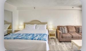 a bedroom with a bed and a couch at Oceanfront Condo at Daytona Beach Resort in Daytona Beach +22 photos