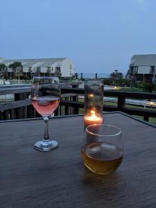 two glasses of wine and a candle on a table at Beautiful view from a peaceful place in St. George Island