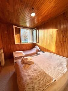 two beds in a room with wooden walls at Positive country in Aulnay-sous-Bois