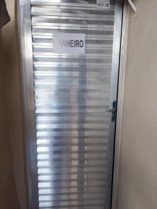 a metal elevator door with a sign on it at Quarto pra OITO 8 Pessoas in Ouro Preto
